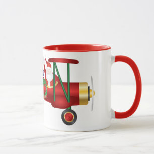 Papá Noel que agita en el biplano con la taza de