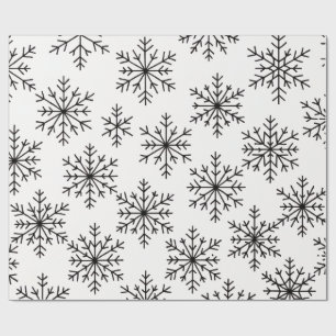 Papel de regalo con patrón de copo de nieve en neg