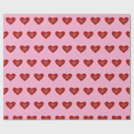 Papel de regalo corazón rojo sobre fondo rosa amor