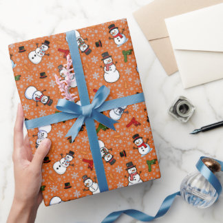 Papel De Regalo Muñecos de nieve y copos de nieve sobre naranja os