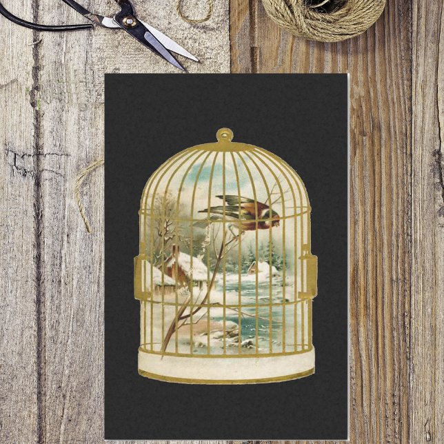 Papel De Seda Escena de invierno de jaulas de pájaro dorado (Golden birdcage with bird overlooking winter cabin in woods scene on black tissue paper for gifts.)