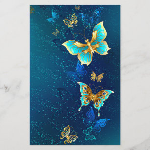 Papelería Mariposas doradas sobre fondo azul