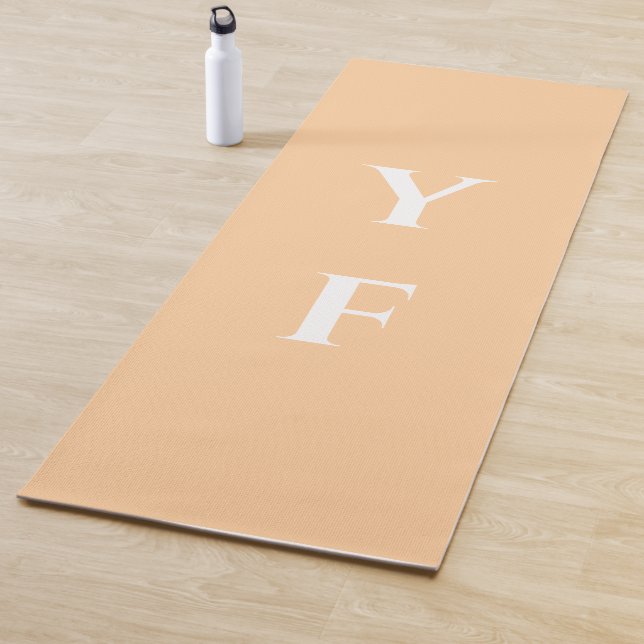 Peach color yoga mat with custom name initials (In situ)