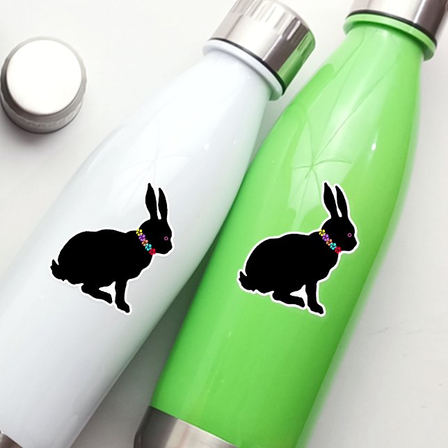 Pegatina Anillo de flores de conejo negro de silueta de pri (Sitting spring time or Easter black silhouette rabbit wearing colourful flowers on vinyl sticker.)