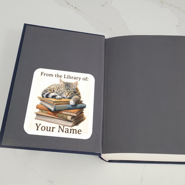 Pegatina Cuadrada Bookplate con Cat on Books (A bookplate showing a cat lying on some books is displayed inside a book.)