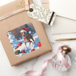 Pegatina Cuadrada Galgo corriendo en la nieve con sombrero de Navida