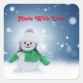 Pegatina Cuadrada Hombre de nieve con una bufanda verde