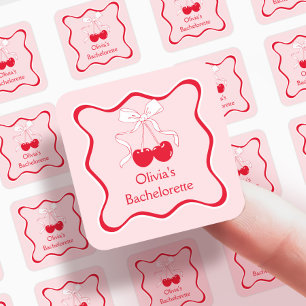 Pegatina Cuadrada Lazo ondulado rojo y rosa, cereza en la parte supe