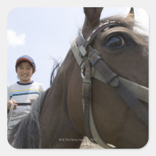 Pegatina Cuadrada Niño montando un caballo