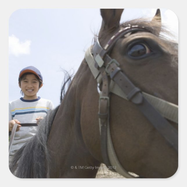 Pegatina Cuadrada Niño montando un caballo (Anverso)