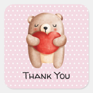 Pegatina Cuadrada Oso de peluche llevando un corazón rojo gracias