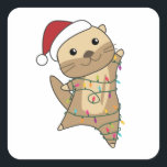 Pegatina Cuadrada Otter Christmas Snow Winter Animals Otter<br><div class="desc">The otter at Christmas with fairy lights. Funny animals with gifts and snow for the holidays. Also funny for Christmas in July. Otters are cute animals and perfect for Christmas.</div>