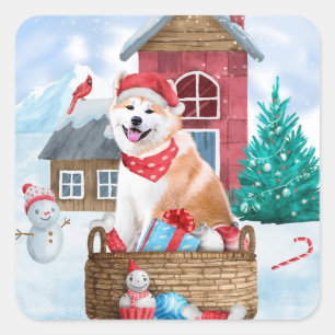 Pegatina Cuadrada Perro Akita en casa de Navidad con nieve
