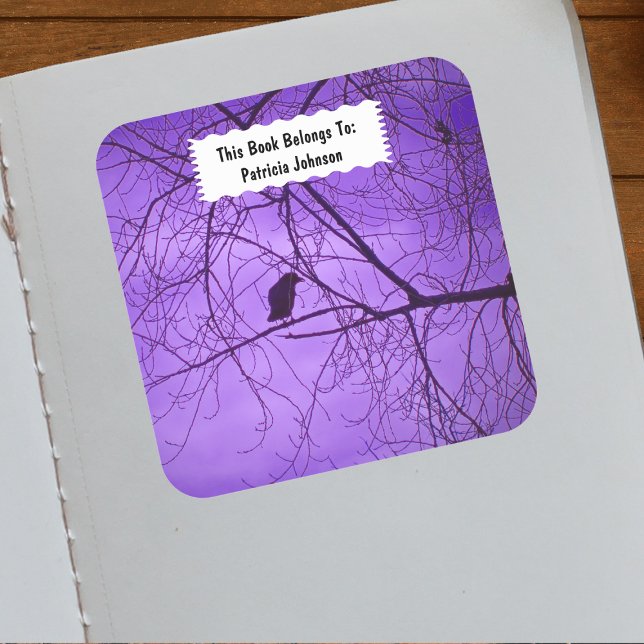 Pegatina Cuadrada Una simple hilera negra de silueta en púrpura de á (Single black crow sitting in tree branches against purple sky on book ownership label.)