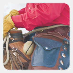 Pegatina Cuadrada Vaquero a caballo que lleva polainas de cuero