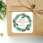 Pegatina Cuadrada Winter Sprigs Wreath Merry Christmas Watercolor<br><div class="desc">Este pegatina de vacaciones personalizado cuenta con una cortina de agua de vegetación de invierno verde y rojo,  que incluye pinares verdes y hojas y bayas huecas. Las palabras "Feliz Navidad" aparecen en letra roja de serif. Personalice el diseño con su apellido en cursiva verde.</div>