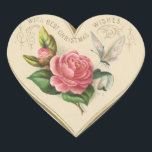 Pegatina En Forma De Corazón Vintage Christmas Rosa y mariposa<br><div class="desc">Este pegatina vintage cuenta con un corazón con un rosa Navidad,  mariposa y saludos. Este encantador pegatina se puede usar en tarjetas,  sobres,  cestas de regalo,  regalos,  etc. ¡Disfruta tu nuevo Rosa Vintage de Navidad y Pegatina del Corazón de Mariposa!</div>