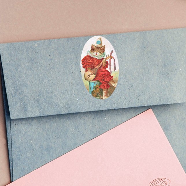 Pegatina Ovalada Gato Mandolin (Cat playing music in red Jester outfit sitting on drum on oval stickers.)