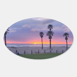 Pegatina Ovalada Puesta de sol en la playa púrpura