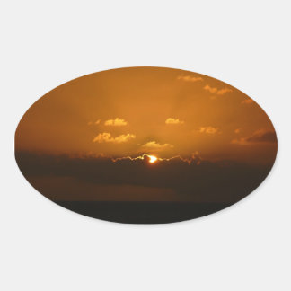Pegatina Ovalada Sun Behind Clouds I Naranja Sunset Photo