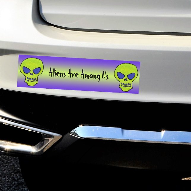 Pegatina Para Coche Green Alien Skull (Two Neon green alien skulls on green and purple Aliens Are Among Us bumper sticker for your car.)