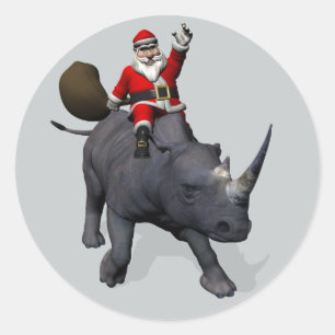 Pegatina Redonda Alegre Papá Noel montado en un rinoceronte