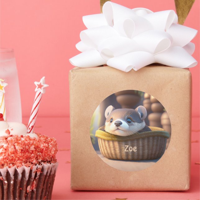 Pegatina Redonda Bebé de nutria en una canasta - niños personalizad (Fiesta)