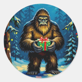 Pegatina Redonda Bigfoot divertido sosteniendo un regalo de Navidad