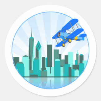 Pegatina Redonda Biplano azul sobre el diseño retro de Nueva York