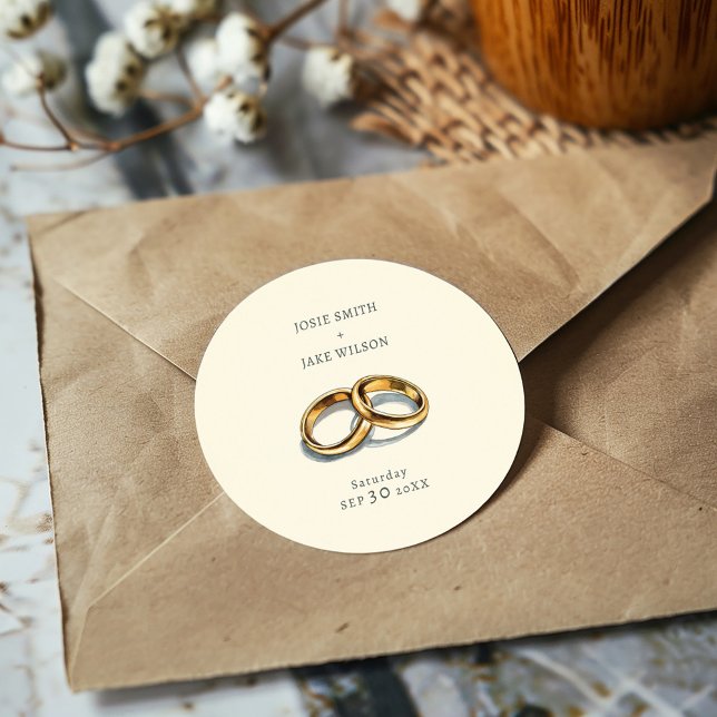 Pegatina Redonda Boda de anillos bodas silenciados (Delicate gold rings on a muted background sticker, evoking elegance and serene romance for weddings.)