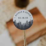Pegatina Redonda Bosque de invierno | Boda personalizado<br><div class="desc">Los pegatinas de moda rústica para su boda al aire libre,  maderera o romántica en invierno cuentan con un bosque de ricos pinos azules y grises con su nombre y fecha boda en letras de bloques.</div>