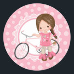 Pegatina Redonda Brunette Bicycle Girl - Pink White<br><div class="desc">This design features a cute brunette girl with her pink bicycle. On pink and white cute scallop accent background.</div>