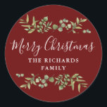 Pegatina Redonda Burgundy Greenery Merry Christmas Family Name<br><div class="desc">La vegetación acuarela enmarca el guión elegante de la tipografía navideña Feliz en estos elegantes pegatinas turísticos de Borgoña. Personaliza con tu apellido. Diseñado por Thisisnotme©</div>