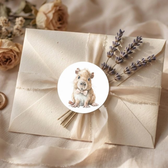 Pegatina Redonda Capybara Baby Shower  (soft neutral sticker with baby capybara bow tie on beige envelope with lavender accents)