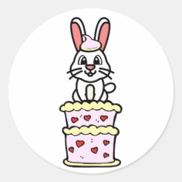 Pegatina Redonda Conejo gracioso saltando de un pastel