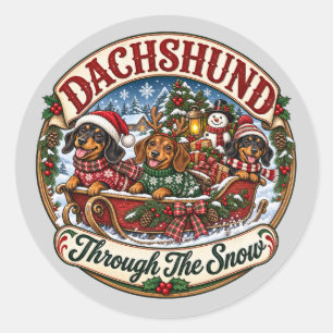 Pegatina Redonda Dachshund a través de la nieve Trineo de Navidad a