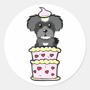 Pegatina Redonda El gracioso perro schnauzer salta de una tarta