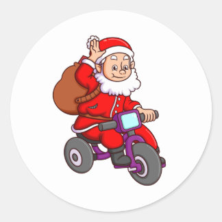 Pegatina Redonda el lindo santa claus está en bicicleta y en wav