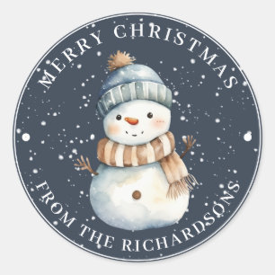 Pegatina Redonda Feliz Navidad Snowman con Gorra en azul