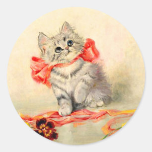 Pegatina Redonda Gatito con un lazo rojo