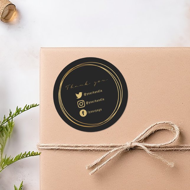 Pegatina Redonda Gracias por tu compra, negro y oro (Black round sticker with gold script, double circle frame, and social media icons.)
