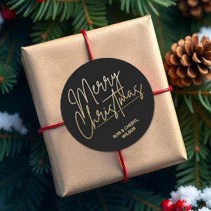 Pegatina Redonda La Feliz Navidad con Guión Dorado en Negro