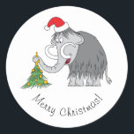 Pegatina Redonda Merry Christmas Tree Cute Mammoth Santa Hat<br><div class="desc">Este divertido Pegatina de la Ronda Clásica presenta al personalizado ilustracion del hermoso Mamut con un Sombrero de Santa y decorando el Árbol de Navidad. La suave nevada agrega más espíritu Navidad.</div>