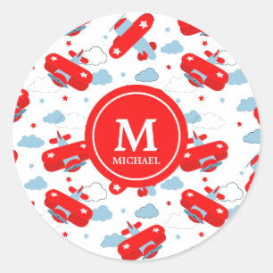 Pegatina Redonda Monograma de aviones y nubes rojas y azules curado
