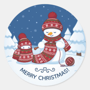 Pegatina Redonda Muñeco de nieve tejiendo bufanda de Navidad