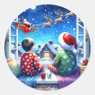 Pegatina Redonda Niños viendo a Santa en la noche de los Navidades