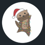 Pegatina Redonda Otter Christmas Snow Winter Animals Otter<br><div class="desc">The otter at Christmas with fairy lights. Funny animals with gifts and snow for the holidays. Also funny for Christmas in July. Otters are cute animals and perfect for Christmas.</div>