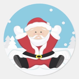 Pegatina Redonda Papá Noel jugando en la nieve.