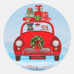 Pegatina Redonda Perro Rottweiler en coche con Papá Noel