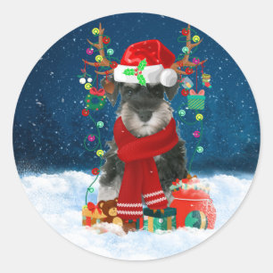 Pegatina Redonda Perro Schnauzer en nieve con regalos de Navidades